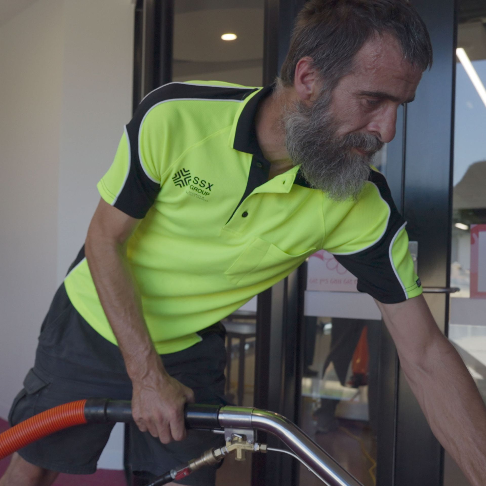 A man with a beard wearing a yellow shirt - SSX group