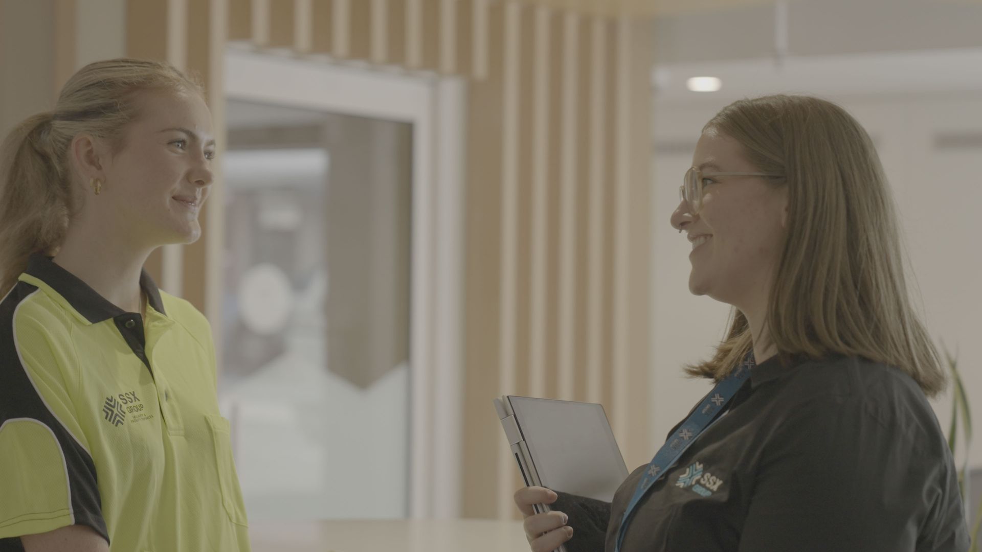 Two individuals interacting in a professional setting.
