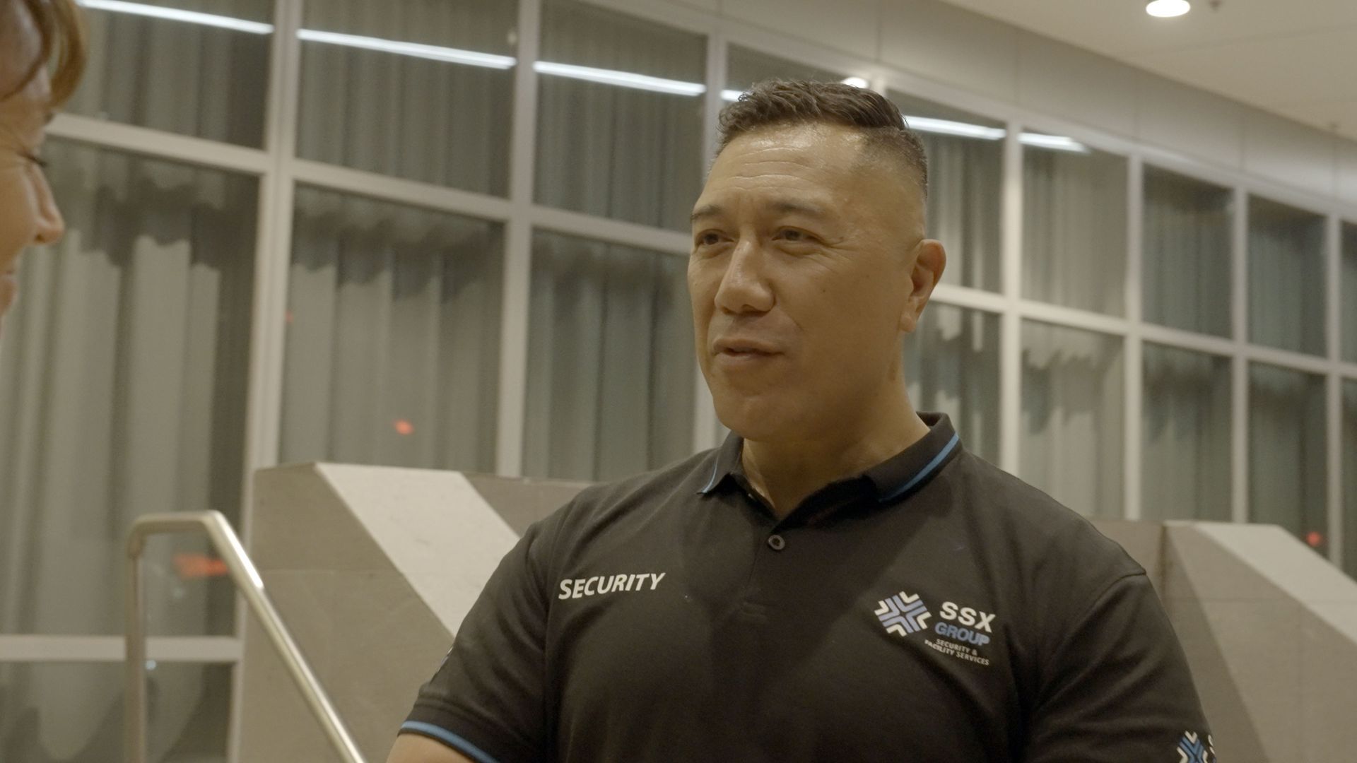 A SSX Group man in a black shirt is talking to his colleague