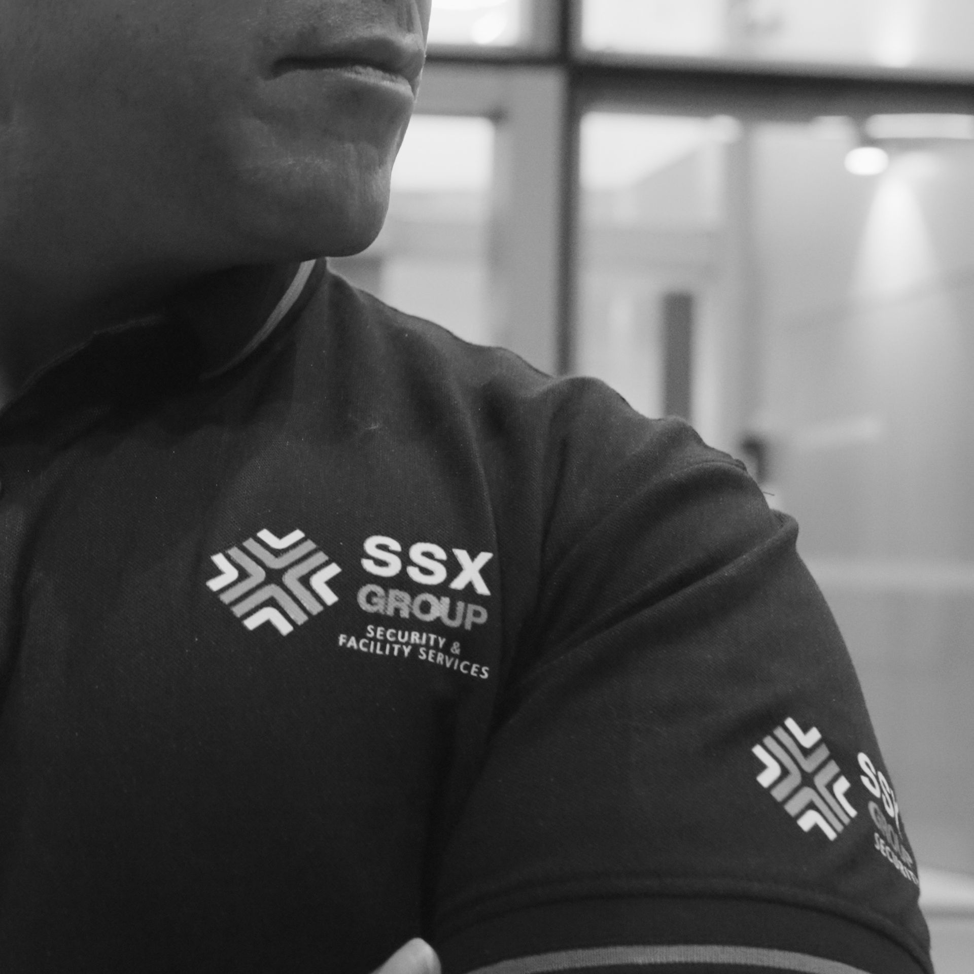 A black and white photo of a man wearing a ssx group shirt