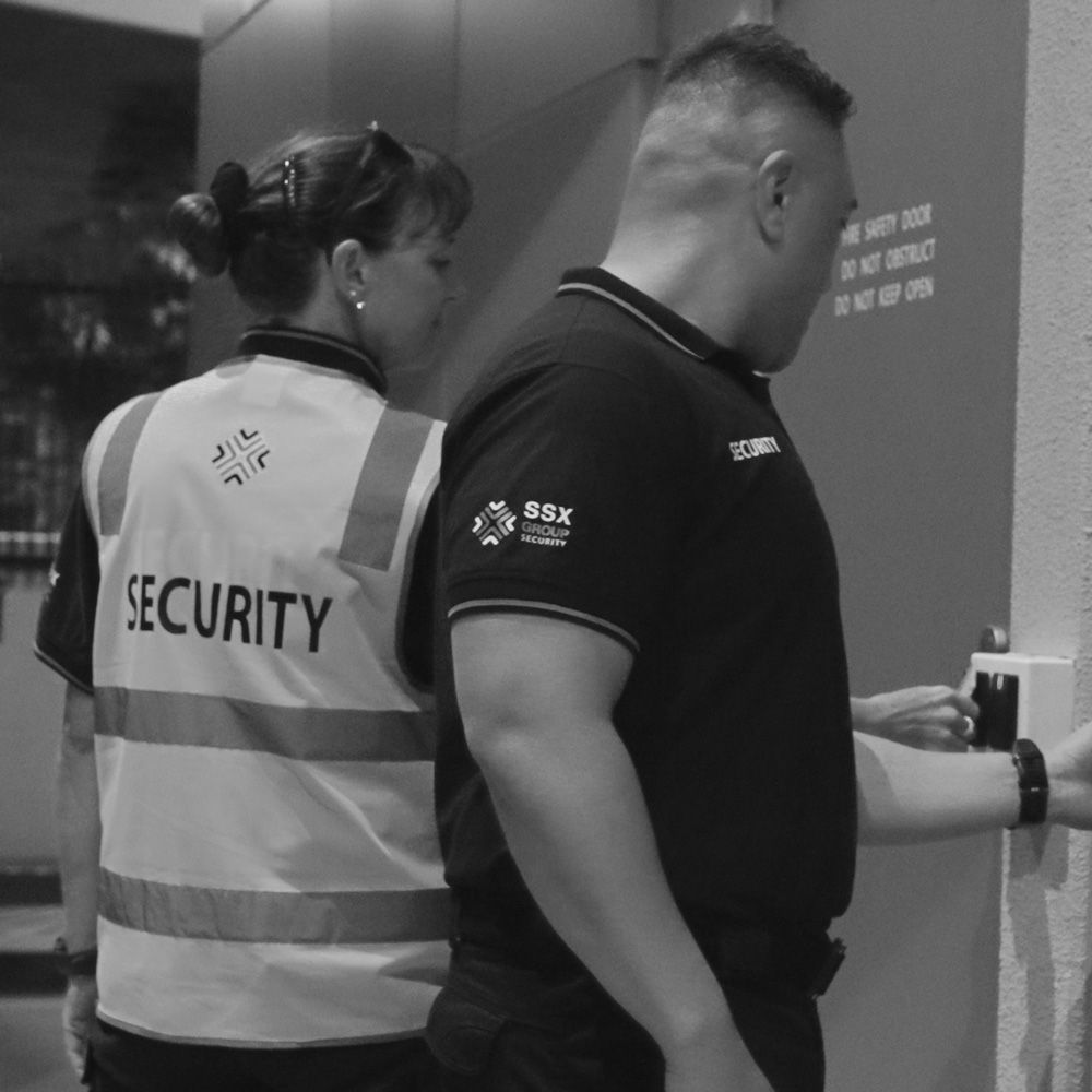 A black and white photo of two security guards from SSX group