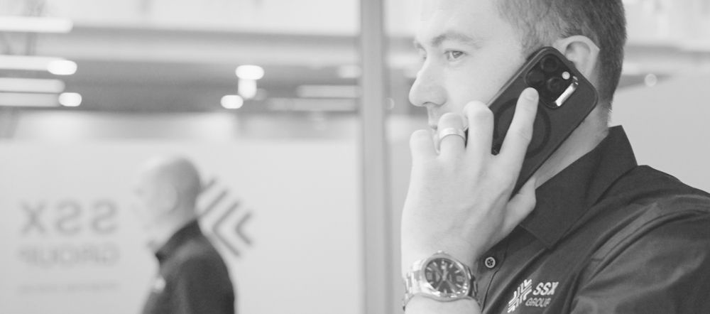 A man is talking on a cell phone in a black and white photo.