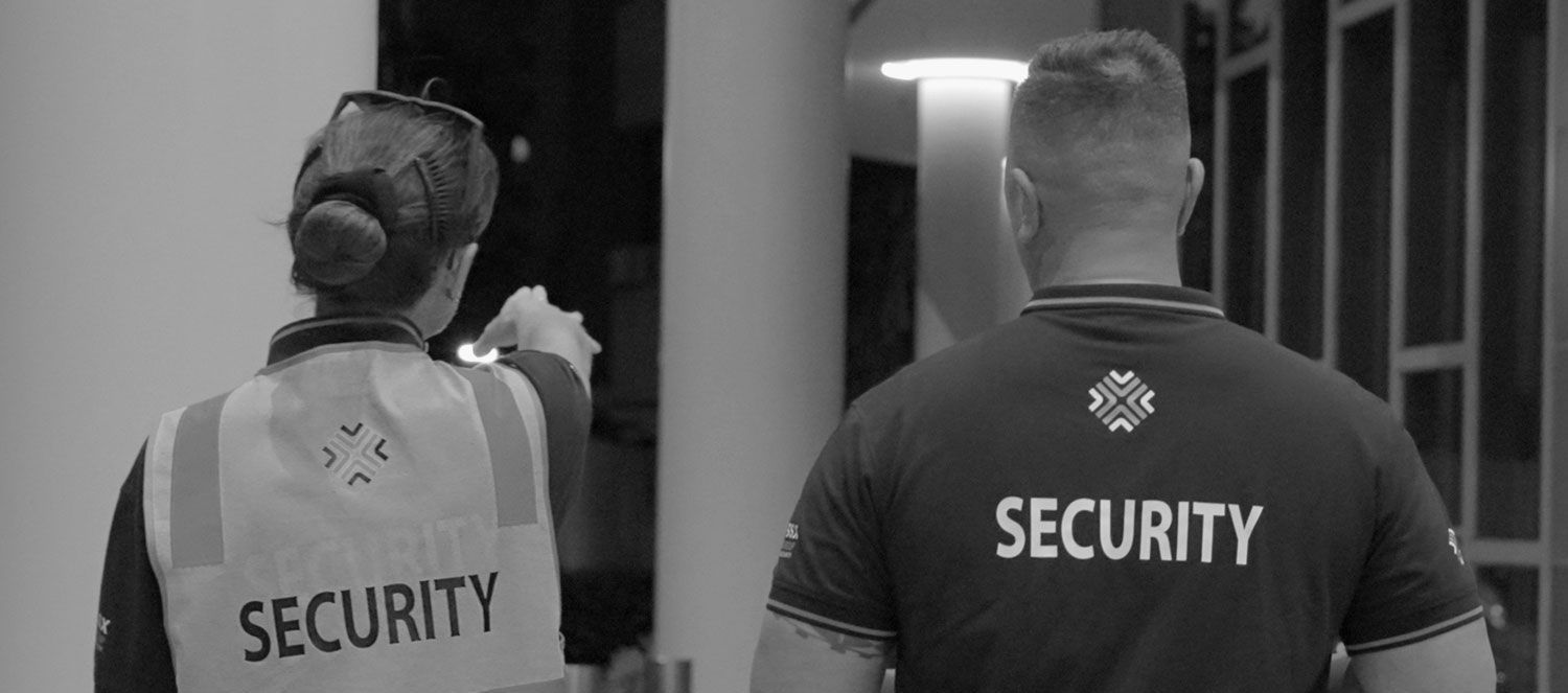 A man and woman are walking in a lobby in a black and white photo.