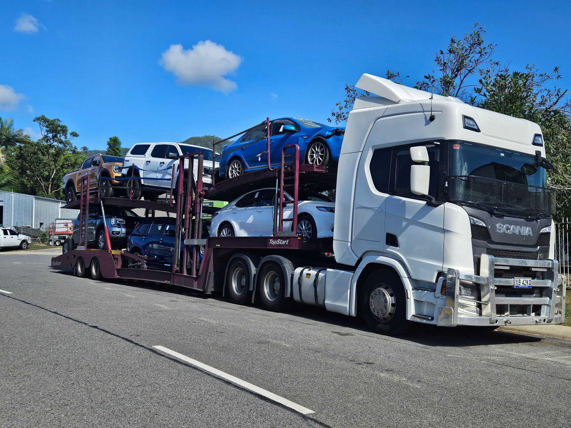 Car Hauler Truck With Multiple Vehicles Parked on the Trailer — Alfie's Towing in Karumba, QLD