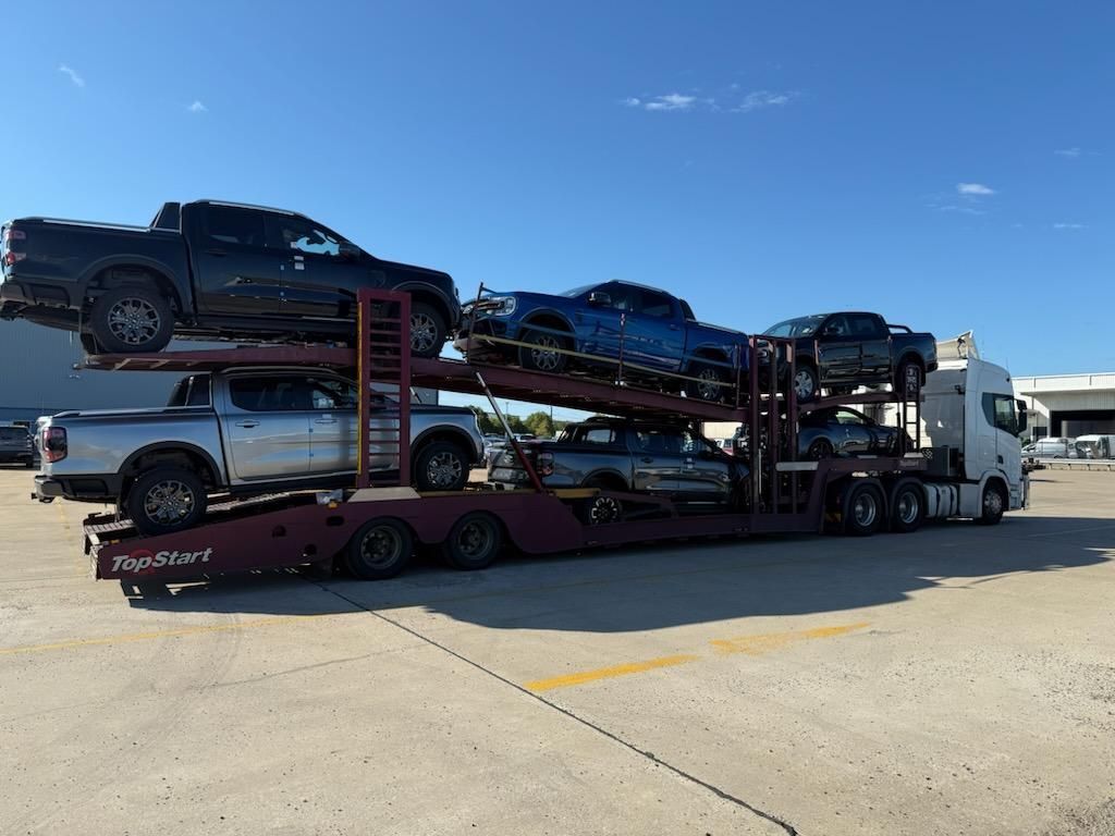 Car Hauler Truck Carrying Multiple Pickup Trucks on a Sunny Day — Alfie's Towing in Bentley Park, QLD