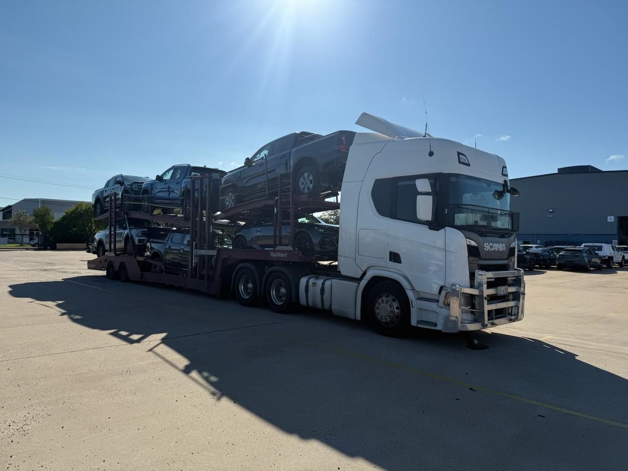 Black Car Being Towed on a Flatbed Tow Truck — Alfie's Towing in Bentley Park, QLD