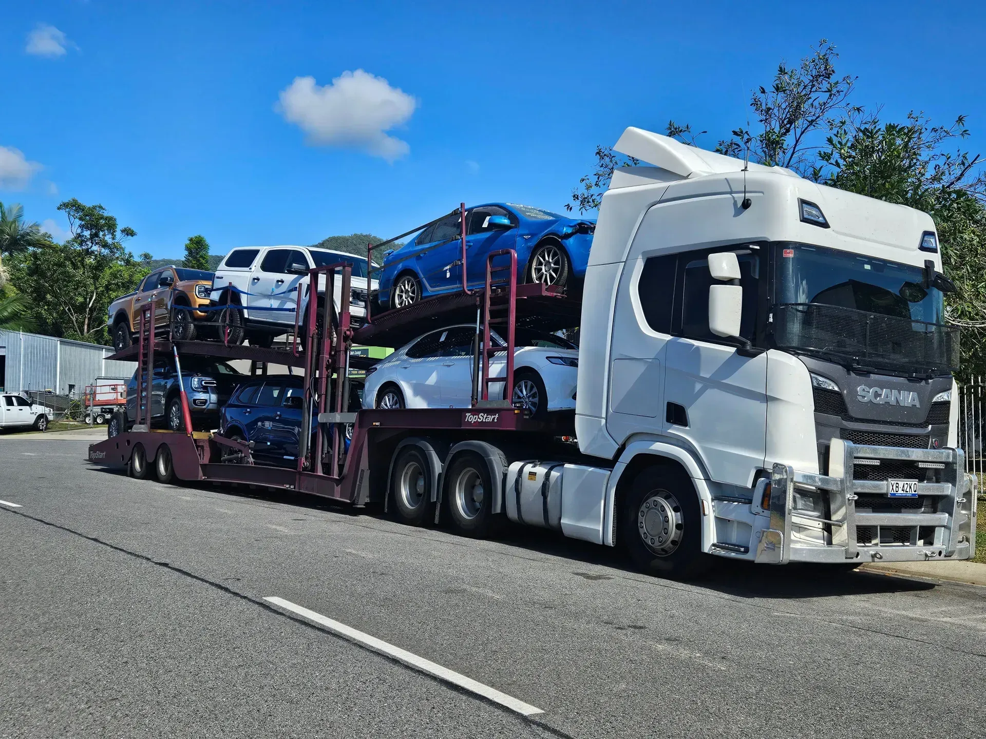 A White Semi-truck Carrying Multiple Cars on a Multi-level Trailer — Alfie's Towing in Bentley Park, QLD