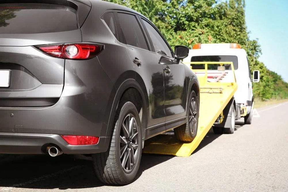 Gray Suv Being Towed by a White Tow Truck on a Road — Alfie's Towing in Bentley Park, QLD