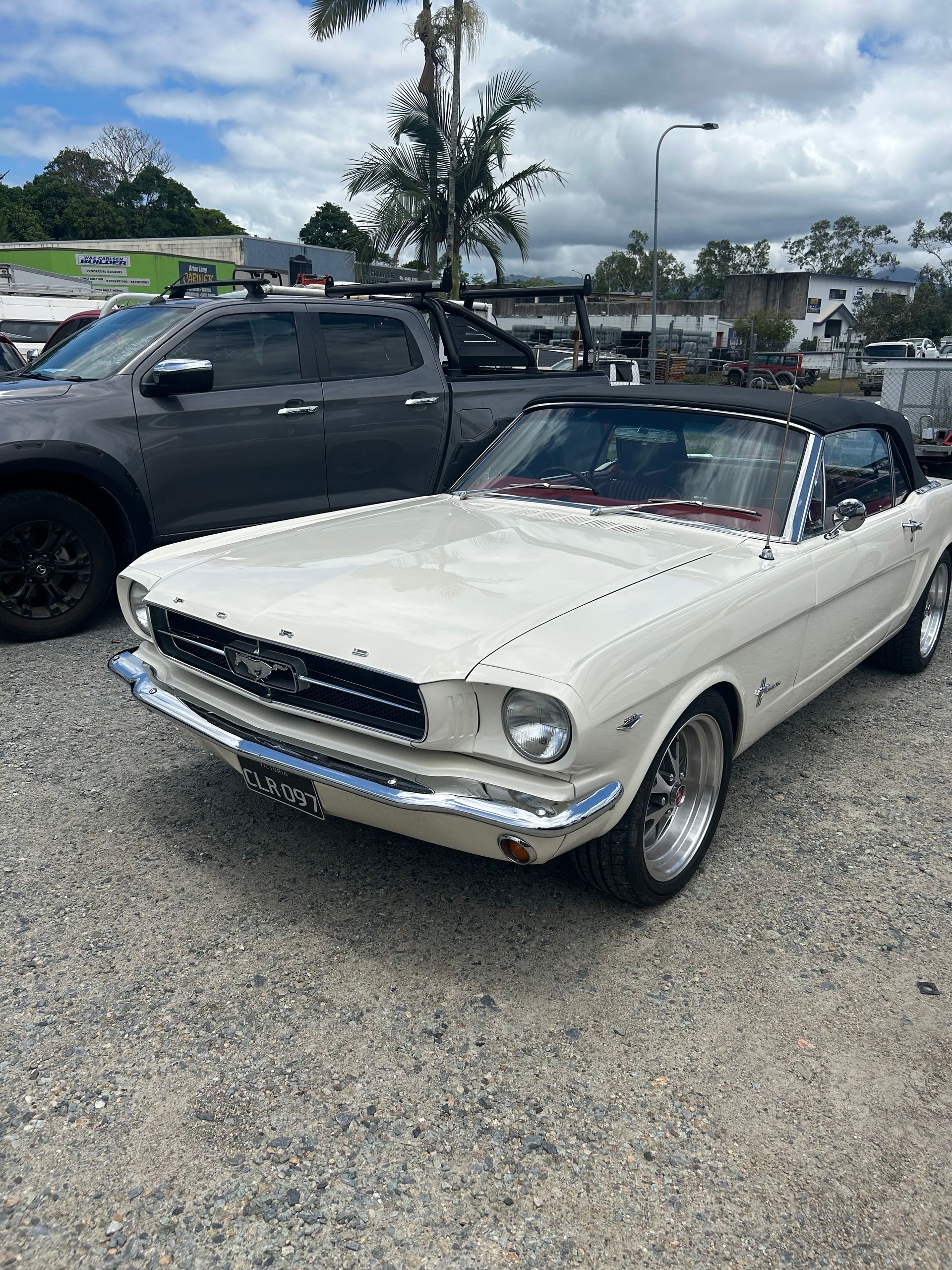 White Convertible Ford Mustang Parked on Gravel Lot — Alfie's Towing in Atherton, QLD