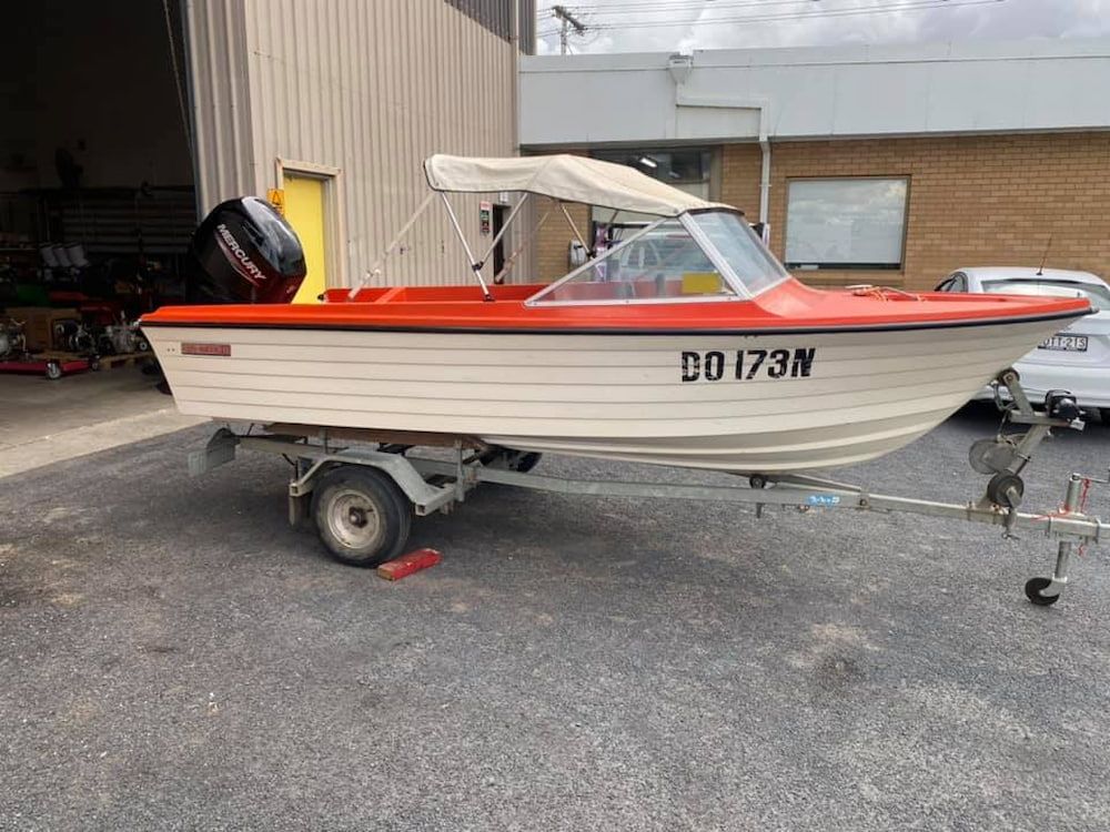 A Small Boat Is Parked In Front Of A Building On A Trailer — Posties Caravans Boats Small Engines Inverell In Inverell, NSW