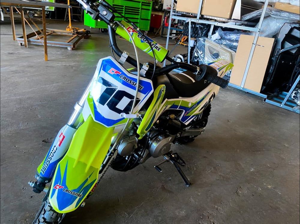 A Green And Blue Dirt Bike With The Number 10 On The Front — Posties Caravans Boats Small Engines Inverell In Inverell, NSW