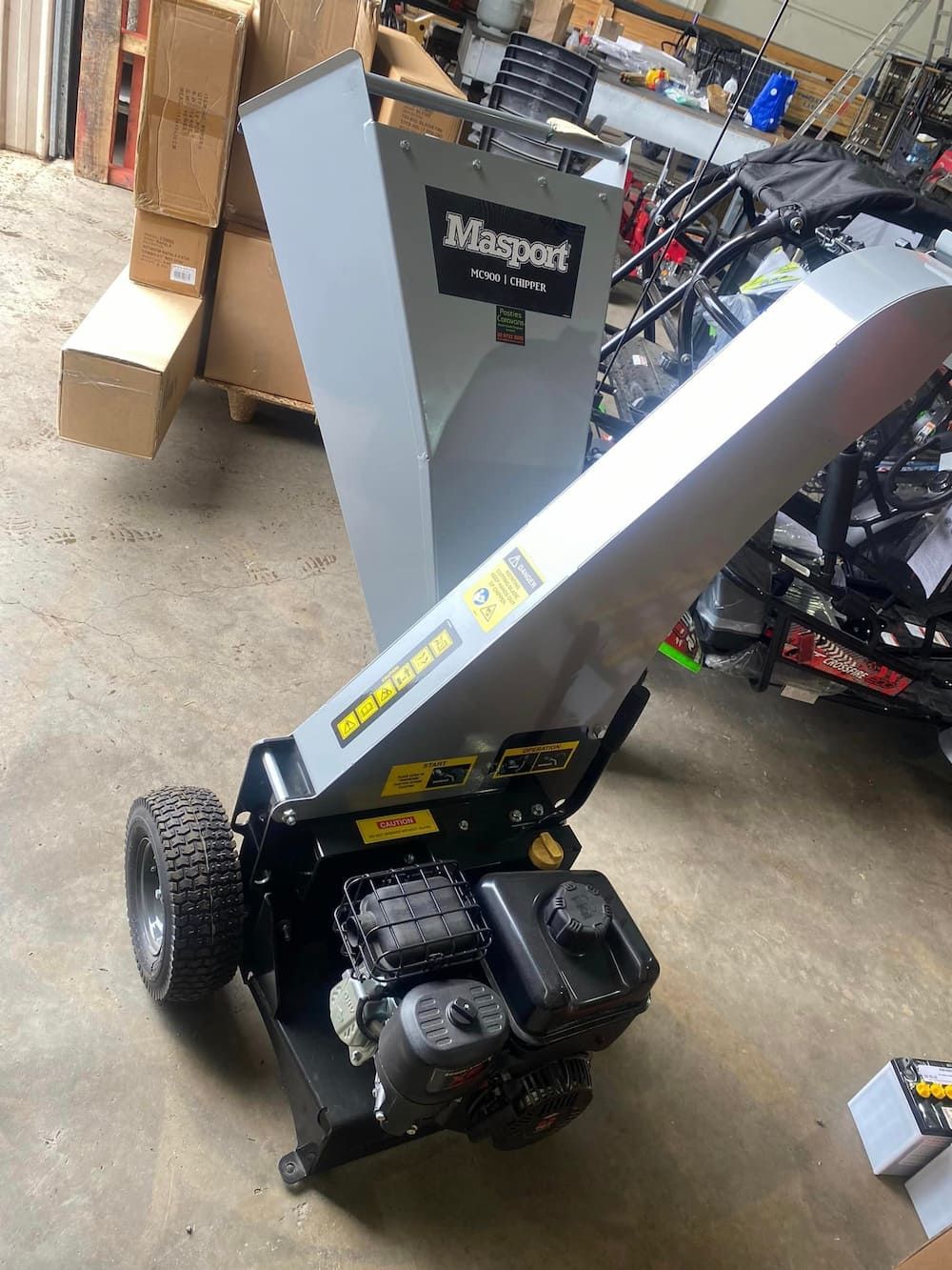 A Tree Chipper Is Sitting On The Ground In A Garage — Posties Caravans Boats Small Engines Inverell In Moree, NSW