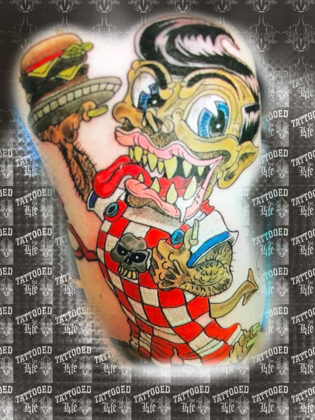 A tattoo of a cartoon character holding a hamburger