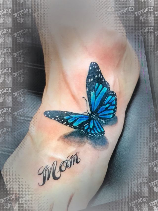 A woman has a blue butterfly tattoo on her foot