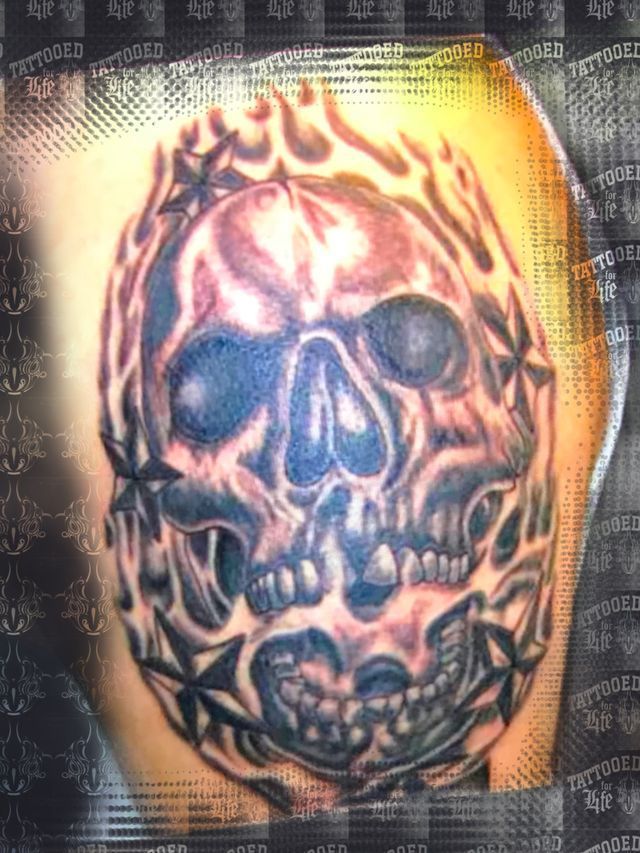 A tattoo of a skull on a person 's arm
