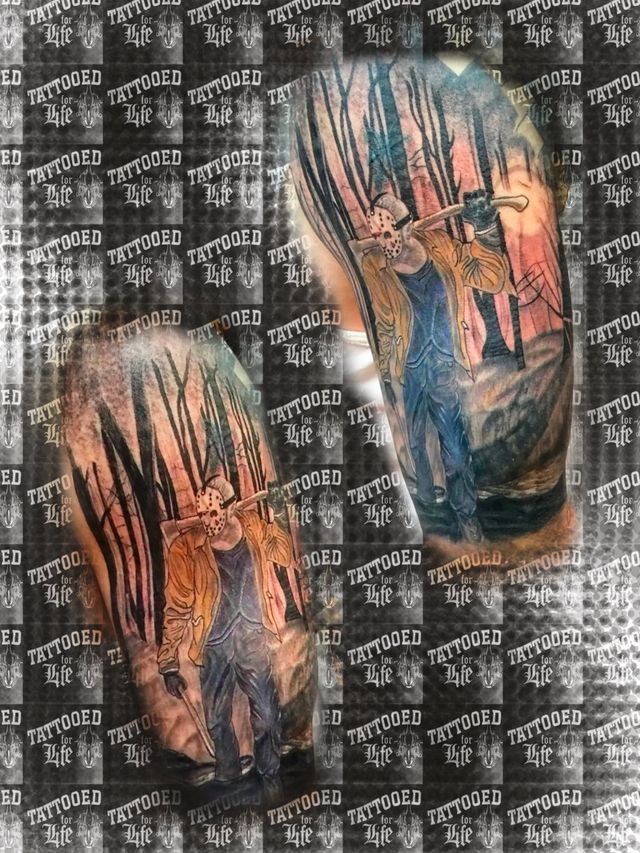 A couple of tattoos on a person 's arm.