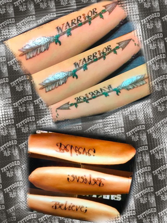 A person has a tattoo on their arm that says warrior