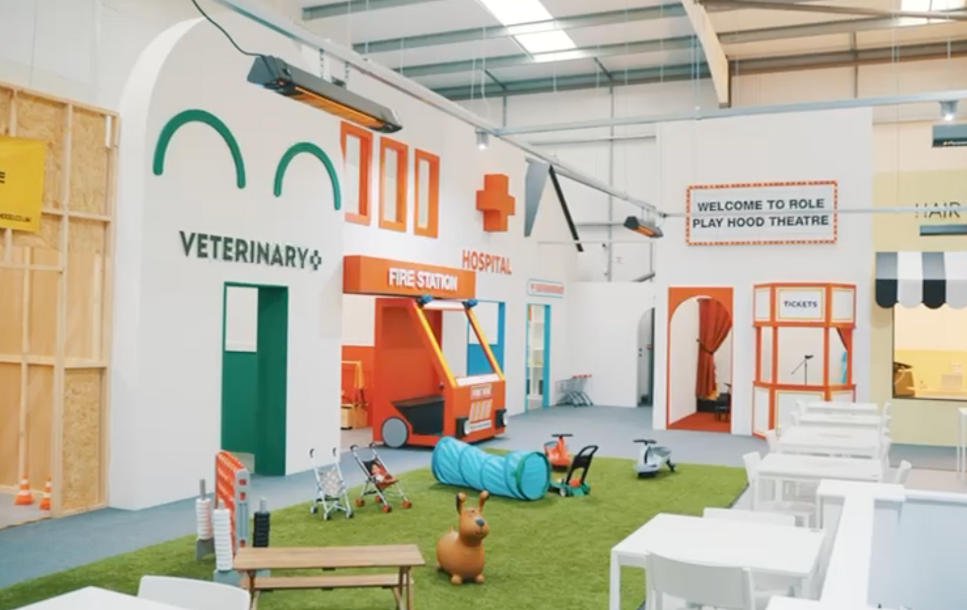 A room with a lot of tables and chairs and a veterinario sign on the wall.