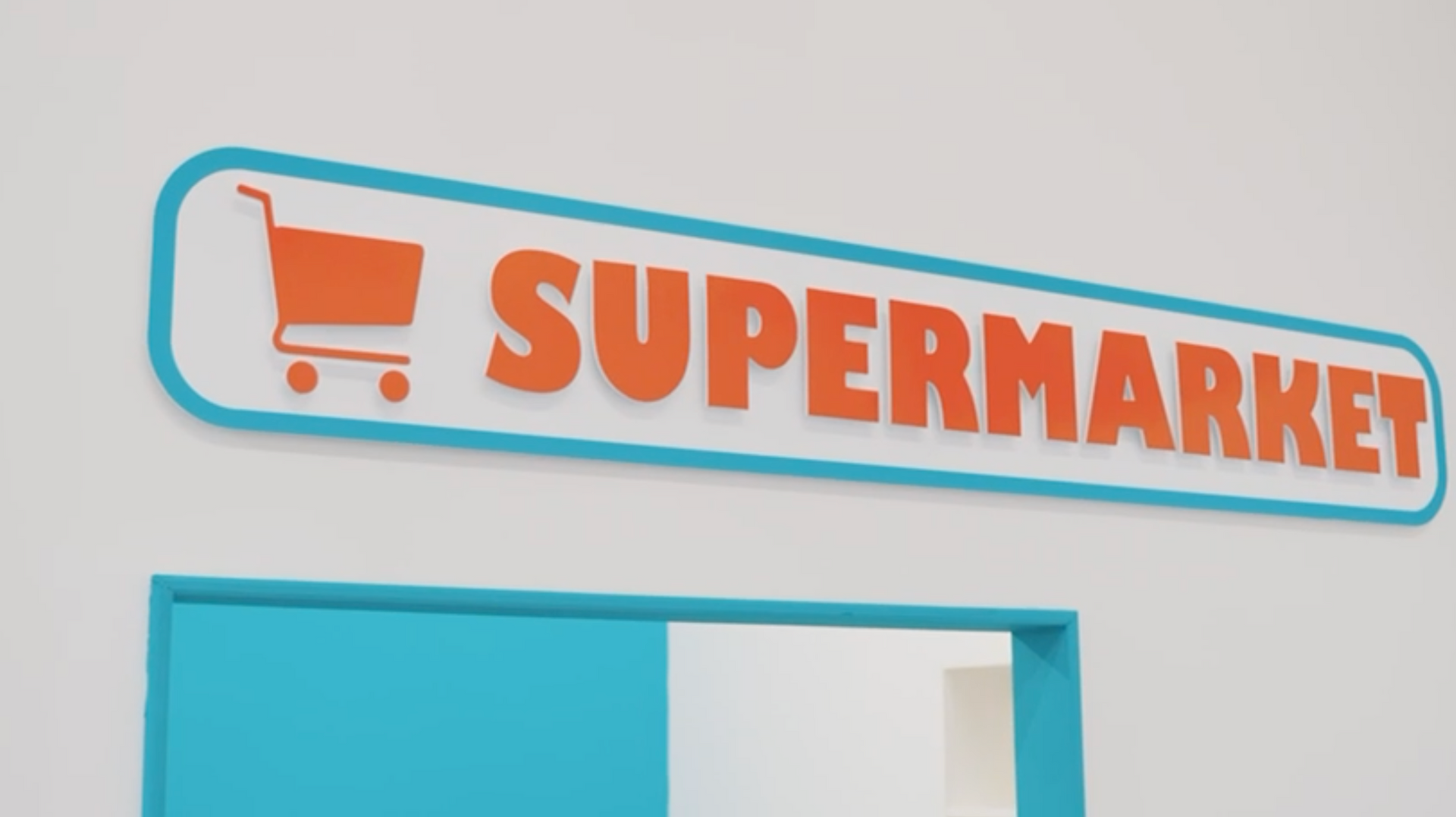 A sign for a supermarket with a shopping cart on it