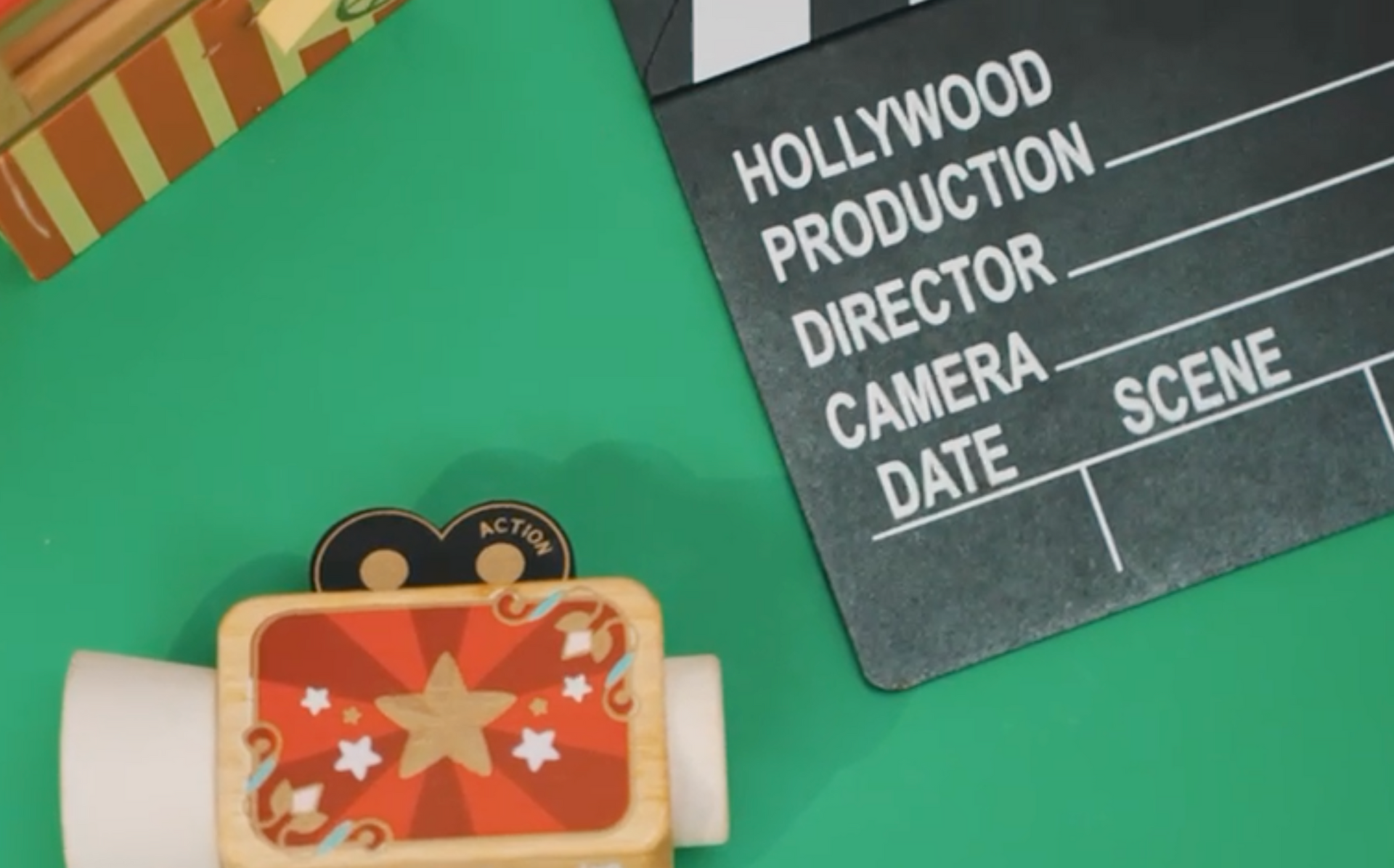 A clapper board with the words hollywood production director camera scene written on it