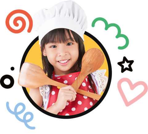 A little girl wearing a chef hat is holding two wooden spoons