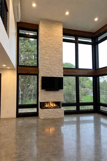 Fireplace with stone facade, a deer head mount, and a wooden mantle.