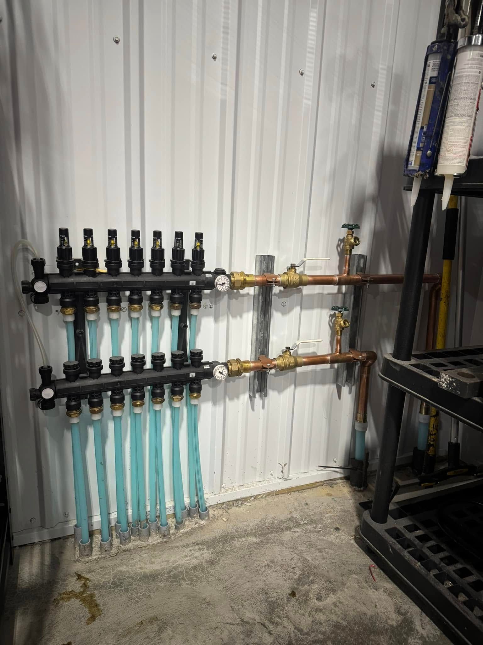 A room with a lot of pipes hanging on the wall.