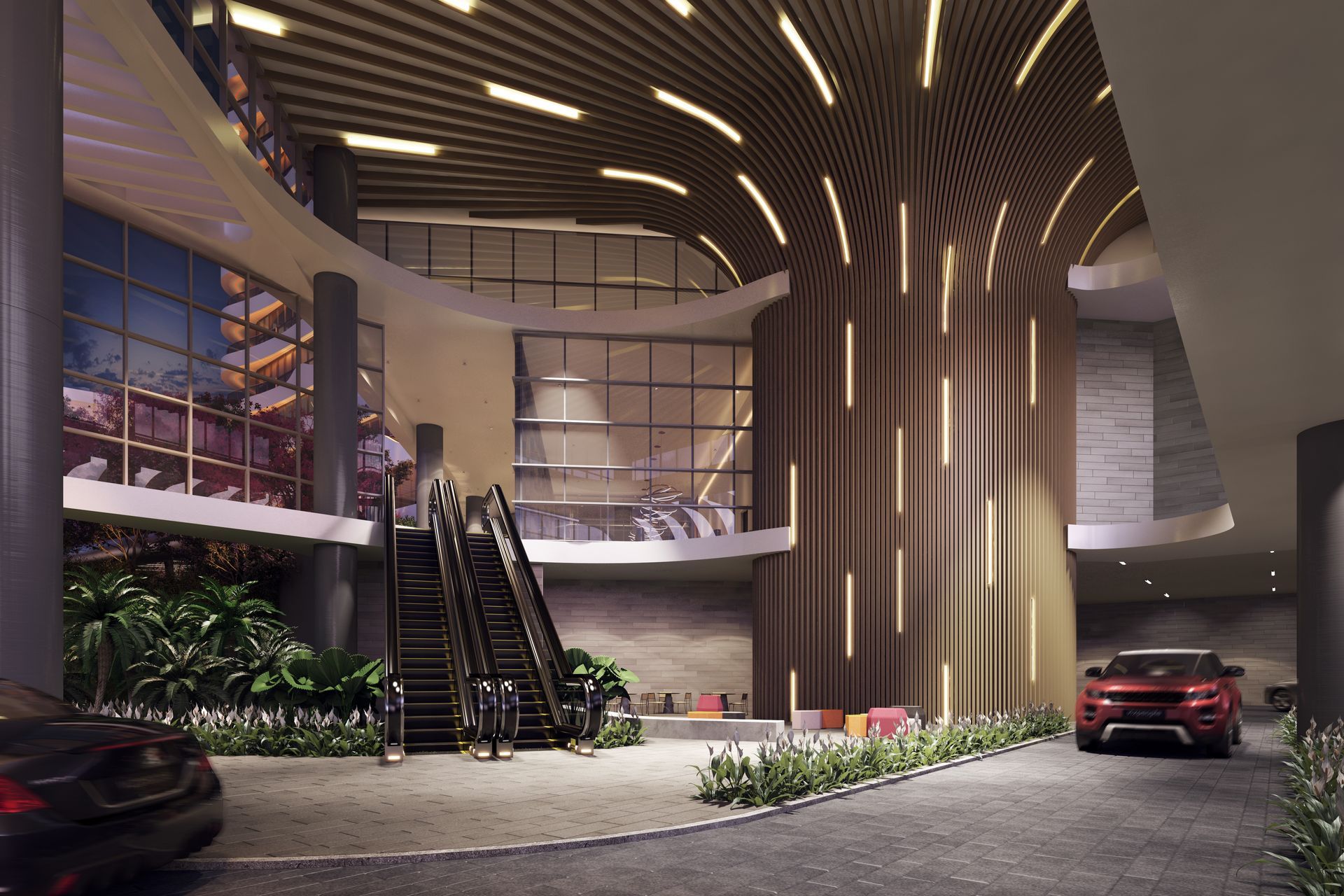 Entrada de edifício moderno com escadas rolantes, carros e iluminação arquitetônica.