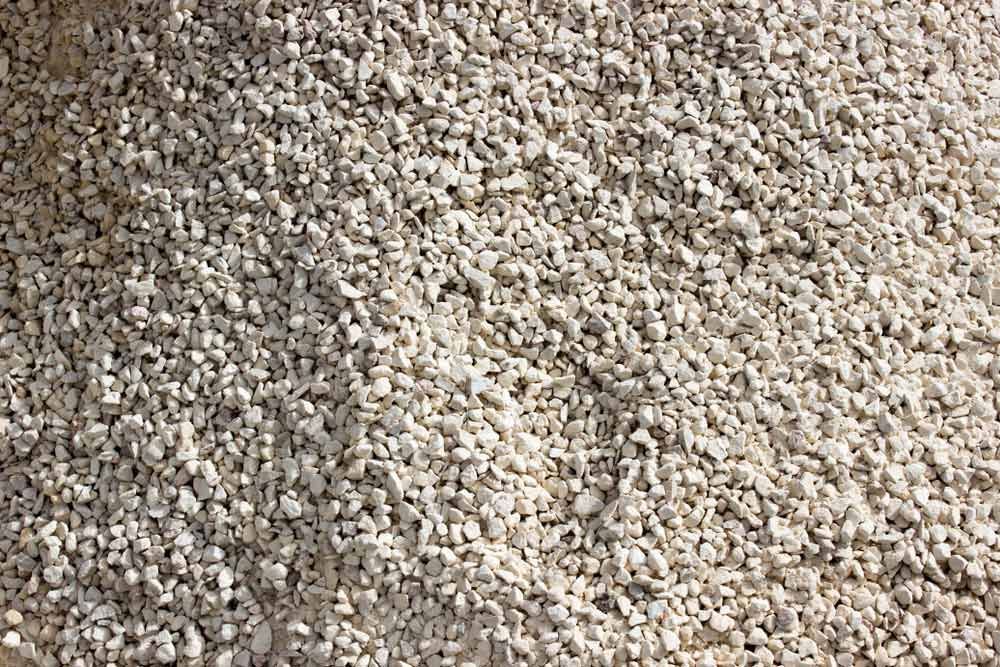A Pile Of White Gravel Is Sitting On A Table — Zappala Raw Materials Pty Ltd In Innisfail, QLD