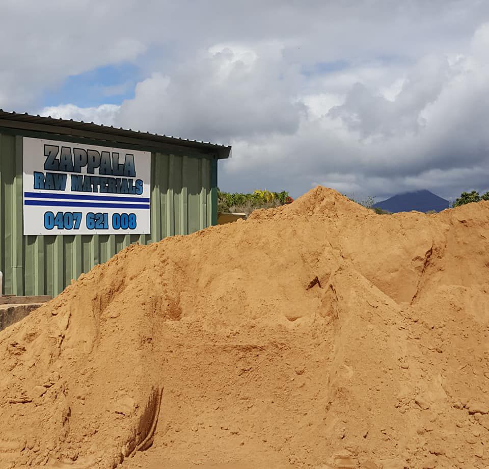 A Pile Of Sand In Front Of A Building That Says Zappila Raw Materials — Zappala Raw Materials Pty Ltd In Edmonton, QLD