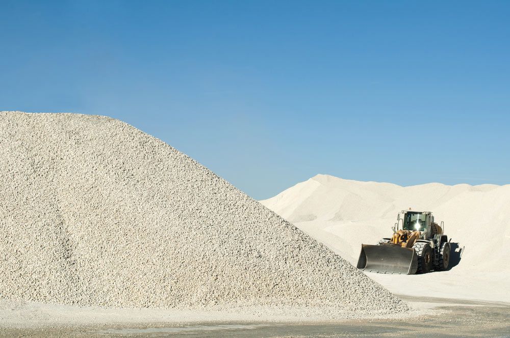 A Bulldozer Is Moving A Large Pile Of Gravel — Zappala Raw Materials Pty Ltd In Mission Beach, QLD