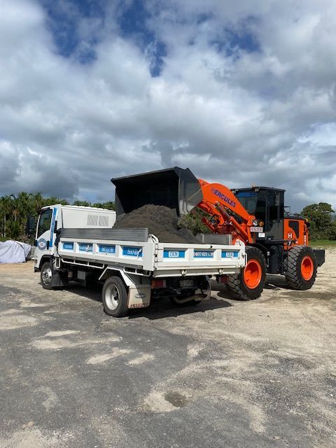 A Bulldozer Is Loading Gravel Into A Truck — Zappala Raw Materials Pty Ltd In Edmonton, QLD