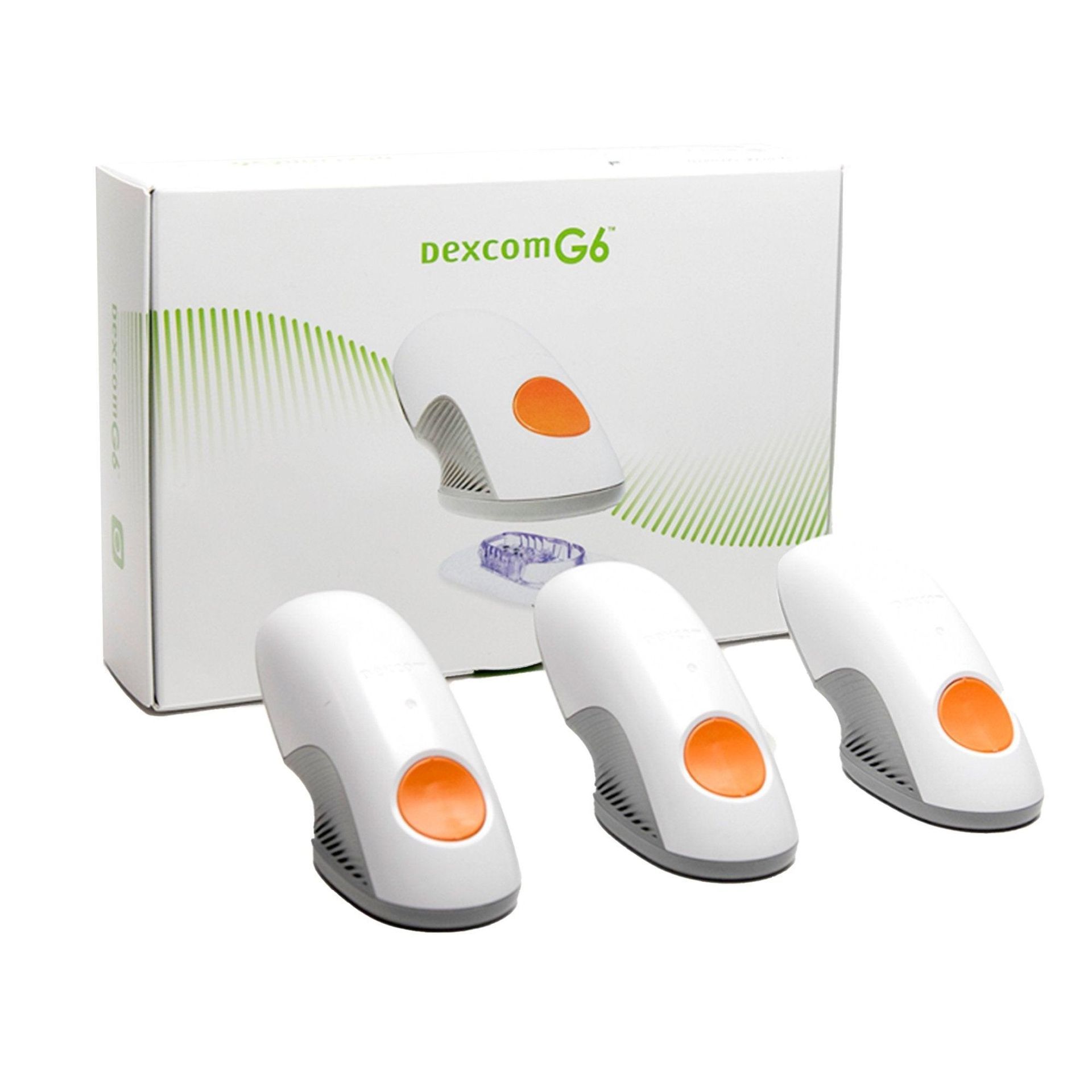 Dexcom G6 glucose monitor sensors and transmitter box on white background
