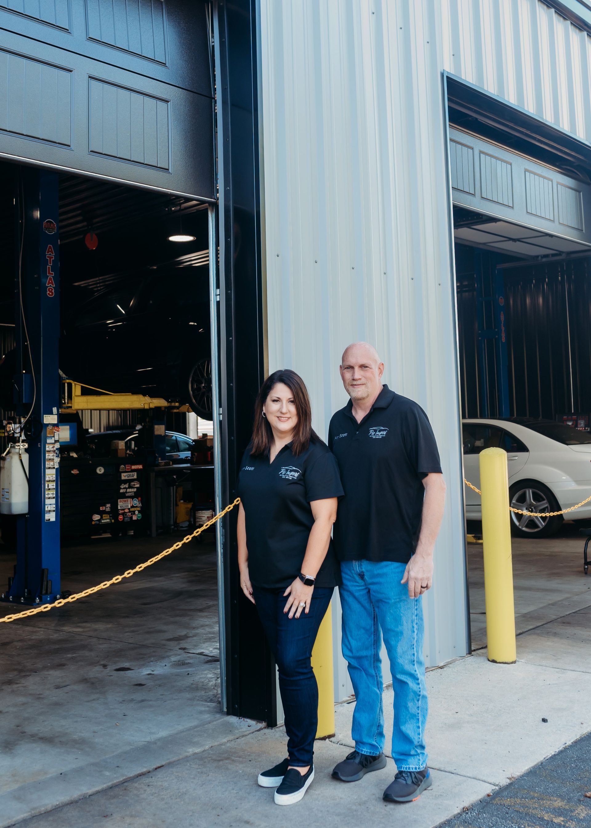 Two people standing at the entrance of an auto shop. | Pro Import Automotive Service and Repair