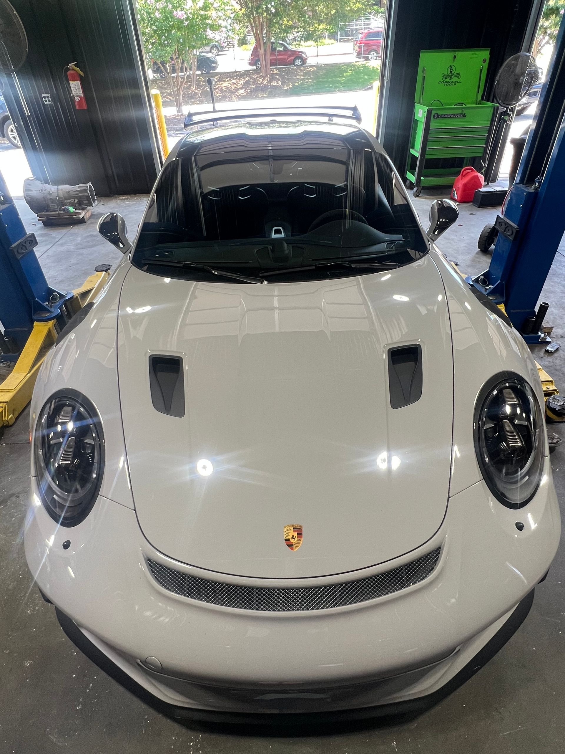 White Porsche sports car in a garage bay, seen from the front | Pro Import Automotive Service and Repair
