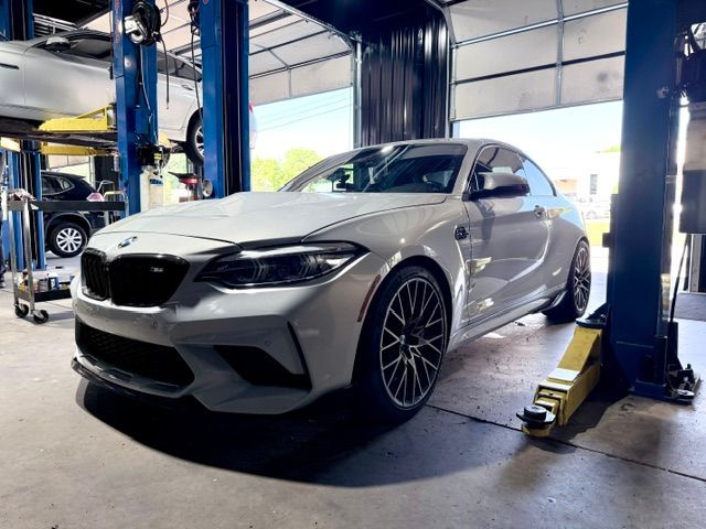Silver sports coupe in an auto shop on a lift | Pro Import Automotive Service and Repair