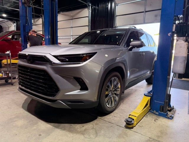 Gray SUV on a lift in an auto repair shop | Pro Import Automotive Service and Repair