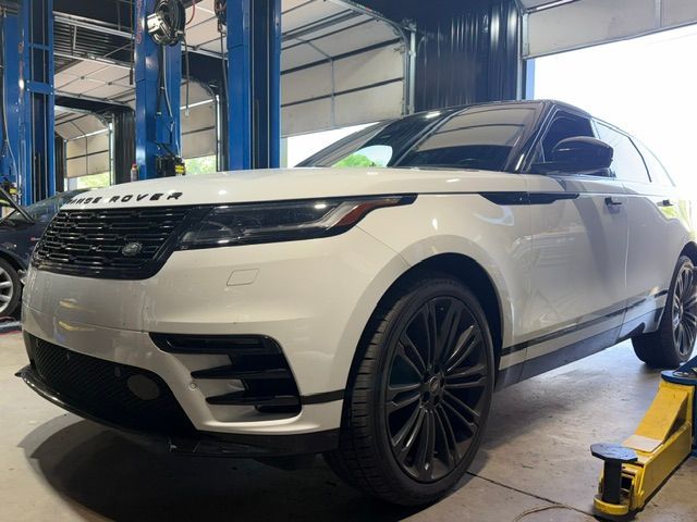 White Range Rover SUV in a garage, viewed from the front-left side on a lift. | Pro Import Automotive Service and Repair