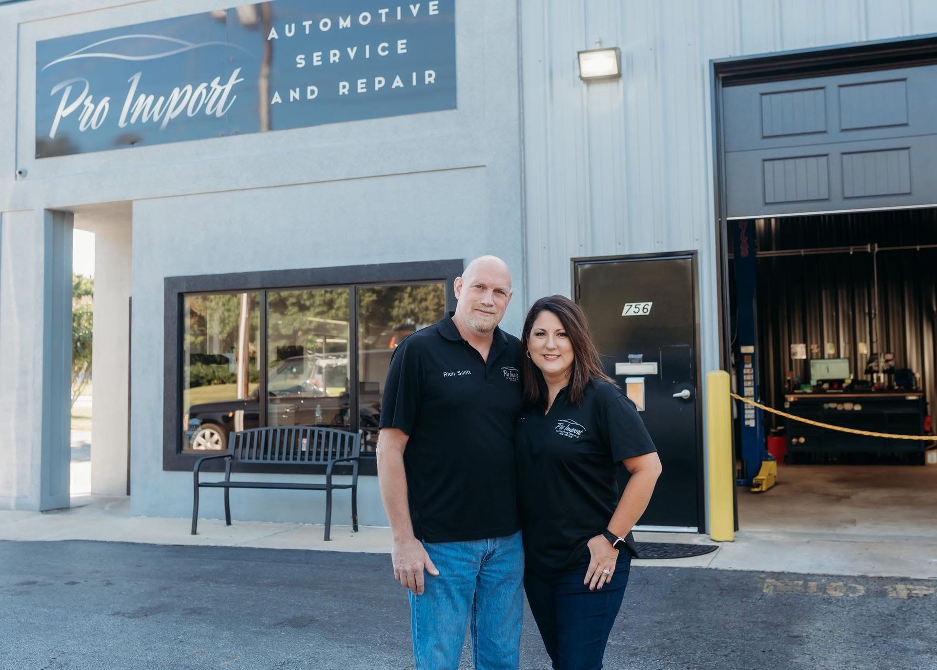 Two people standing outside The Import automotive service shop | Pro Import Automotive Service and Repair