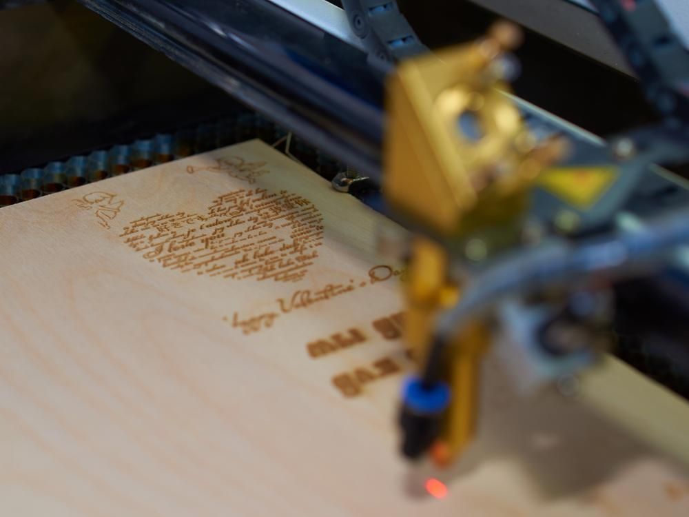 A Machine is Engraving a Heart on a Piece of Wood  — Jimani Trophies & Engraving In Dapto, NSW