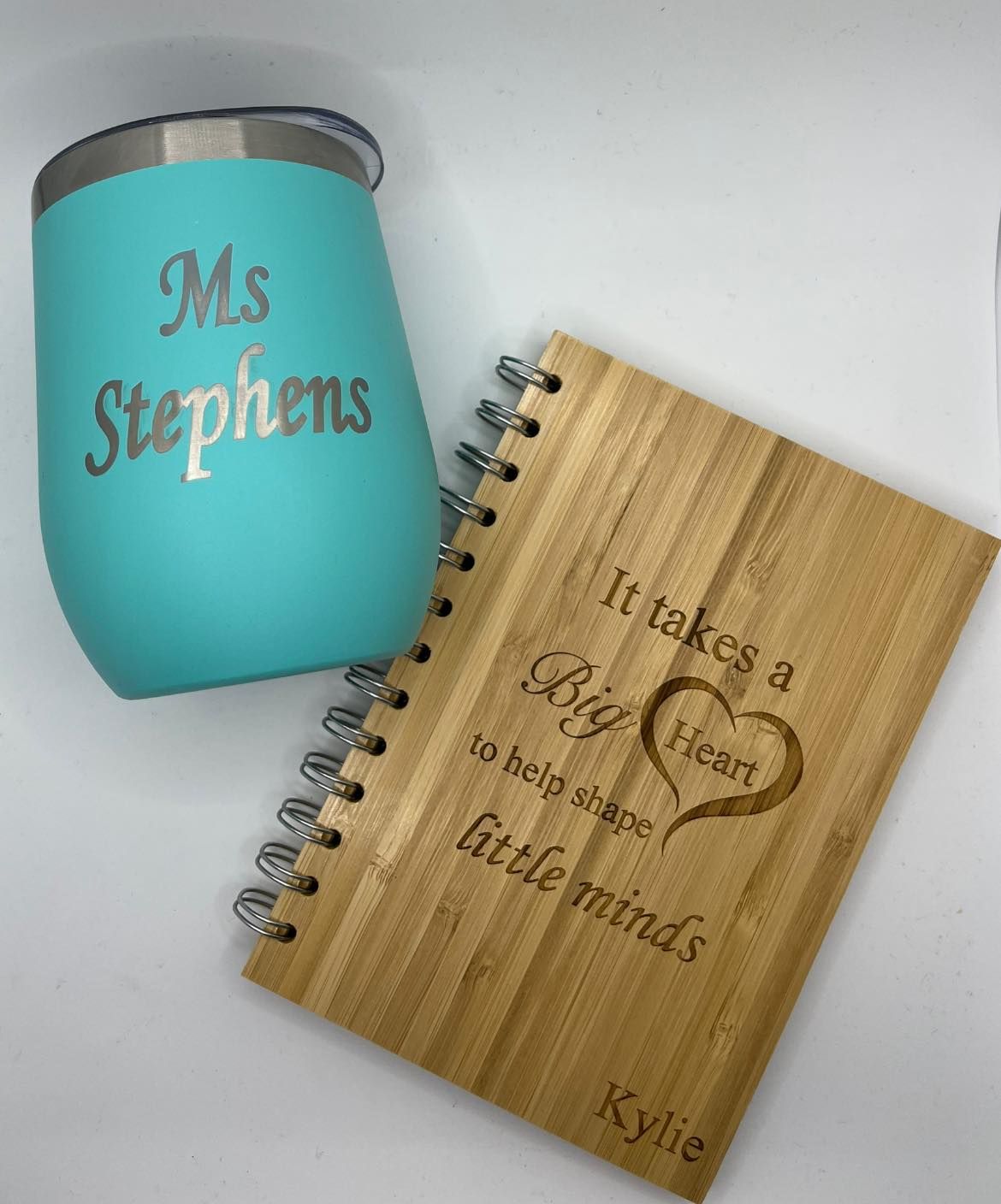 A Wooden Notebook and a Stainless Steel Cup With the Name Ms Stephens on It — Jimani Trophies & Engraving In Dapto, NSW