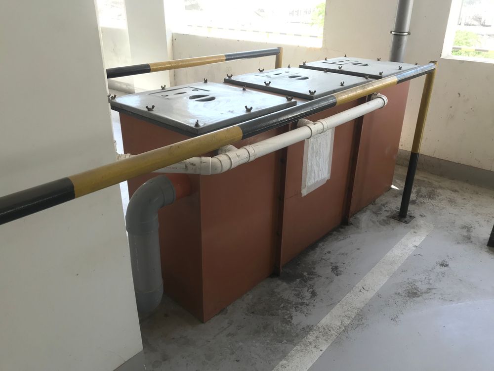 A Row Of Trash Cans Are Sitting Next To Each Other In A Room — Liquid Waste Disposal in Wauchope, NSW