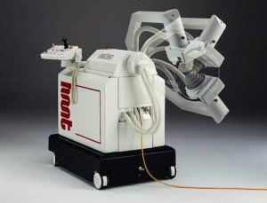 White surgical robot with multiple arms, red