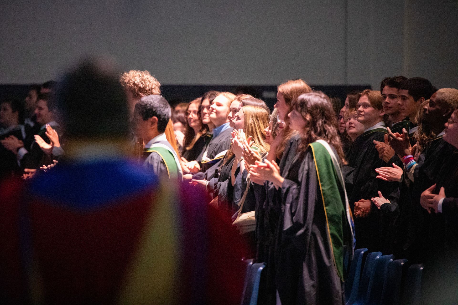 Graduates applauding at a ceremony