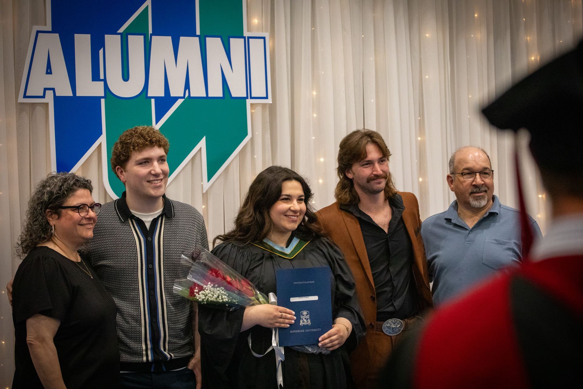 Nipissing University graduate with their family