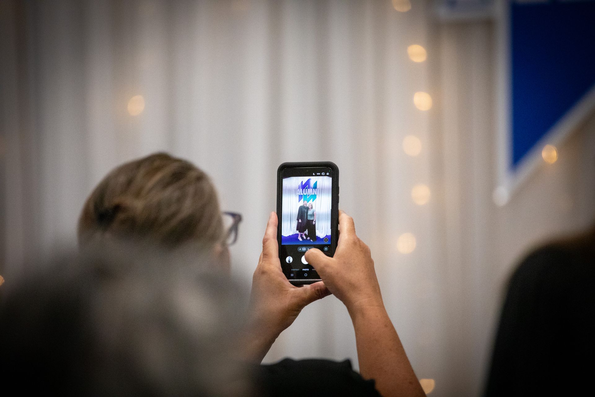 Person holding a phone to photograph 