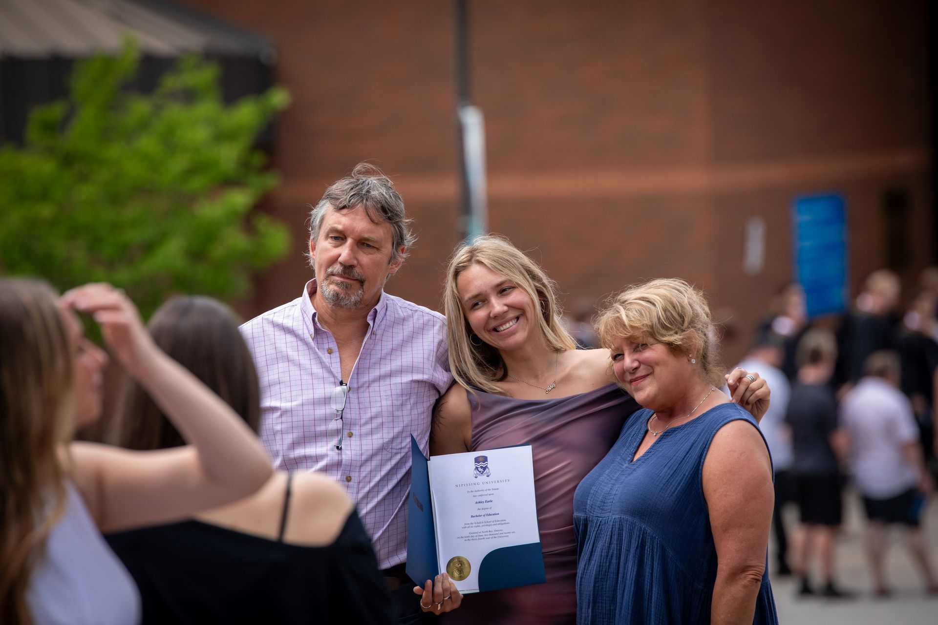 Nipissing University graduate with their family