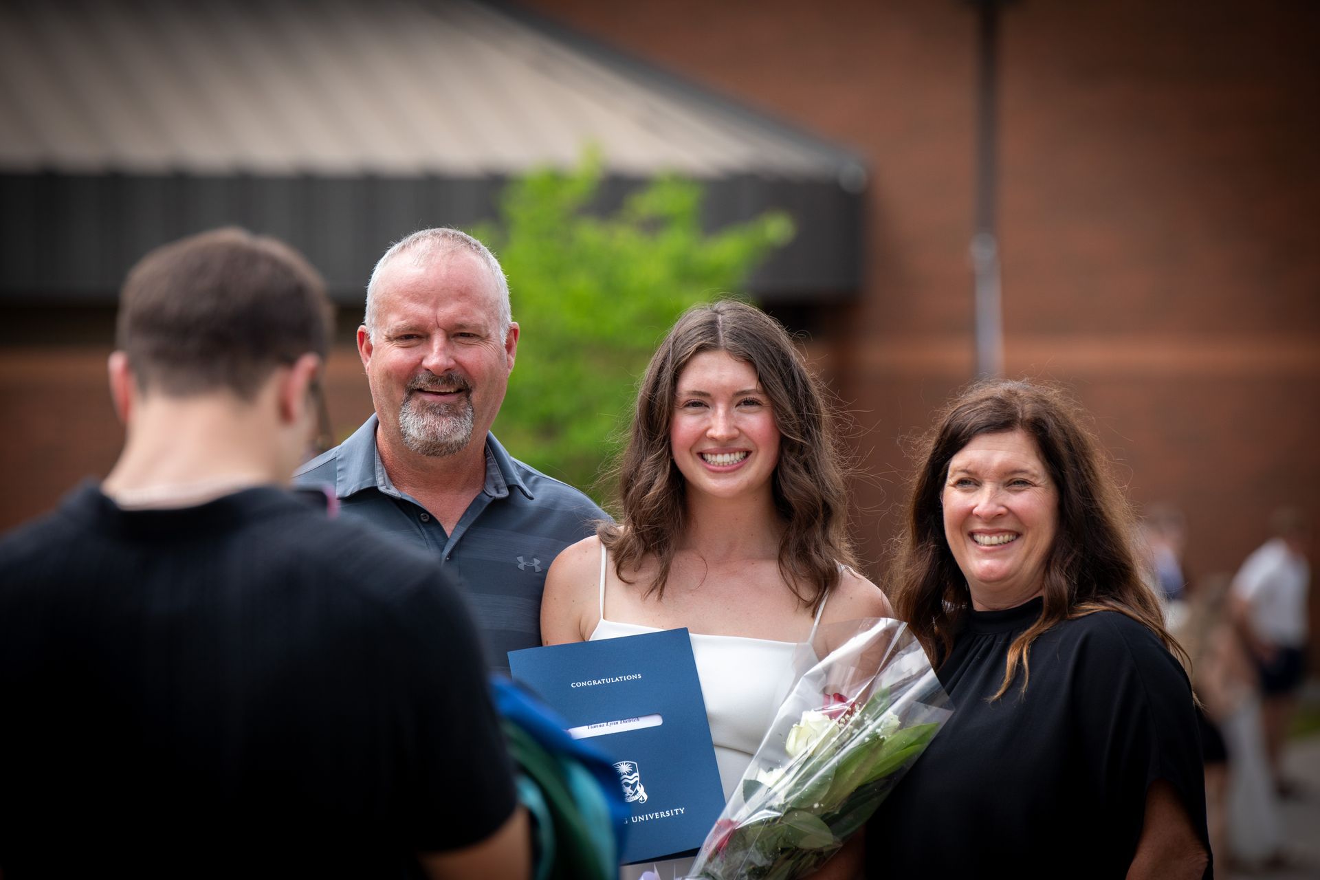 Nipissing University graduate with their family