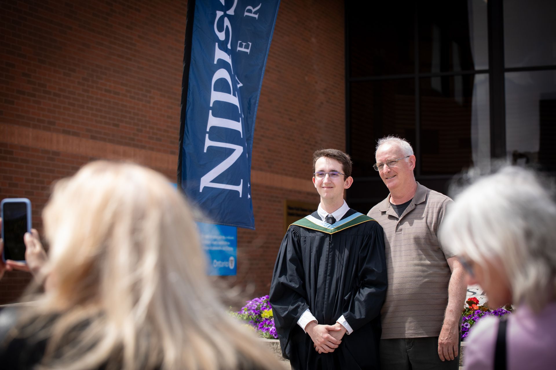 Nipissing University graduate with their family
