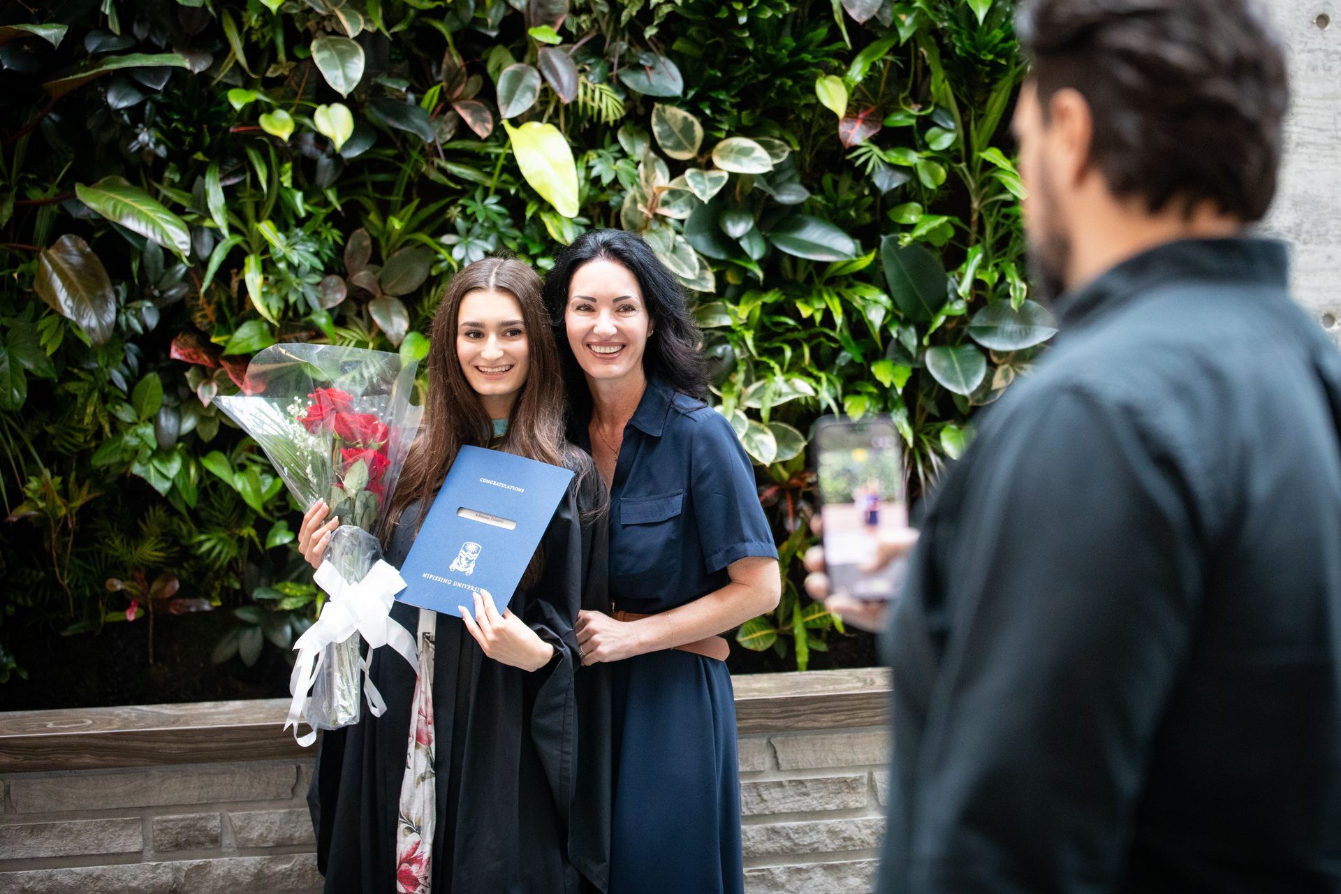 Nipissing University graduate with their family